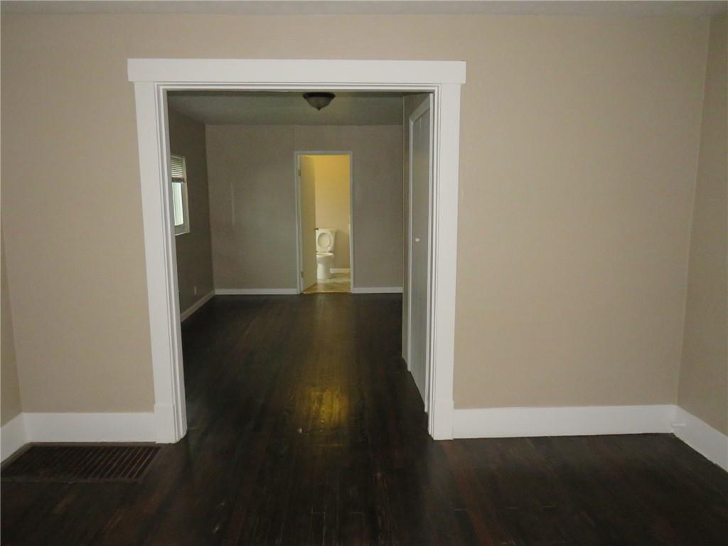 718 Ridge Avenue McKees Rocks, PA 15136 - Photo 3 of 30 an empty room with wooden floor and a bench