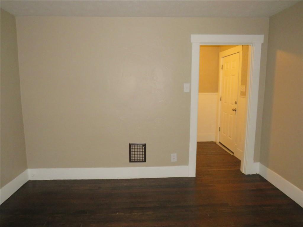 718 Ridge Avenue McKees Rocks, PA 15136 - Photo 4 of 30 a view of an empty room with wooden floor and a window