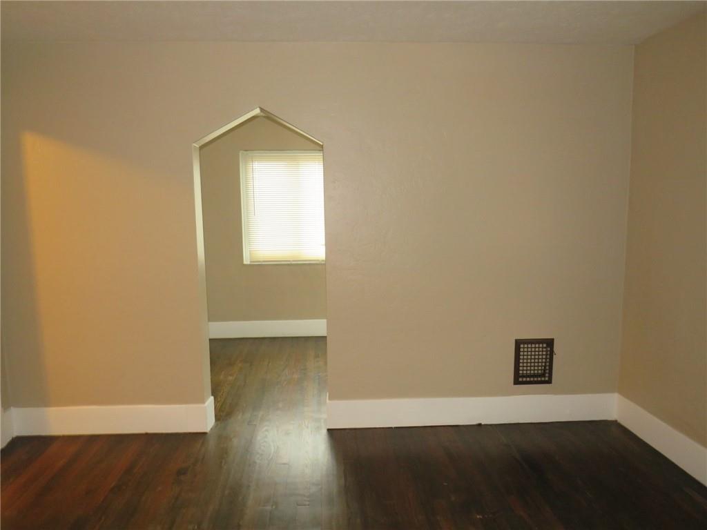 718 Ridge Avenue McKees Rocks, PA 15136 - Photo 5 of 30 an empty room with wooden floor and windows
