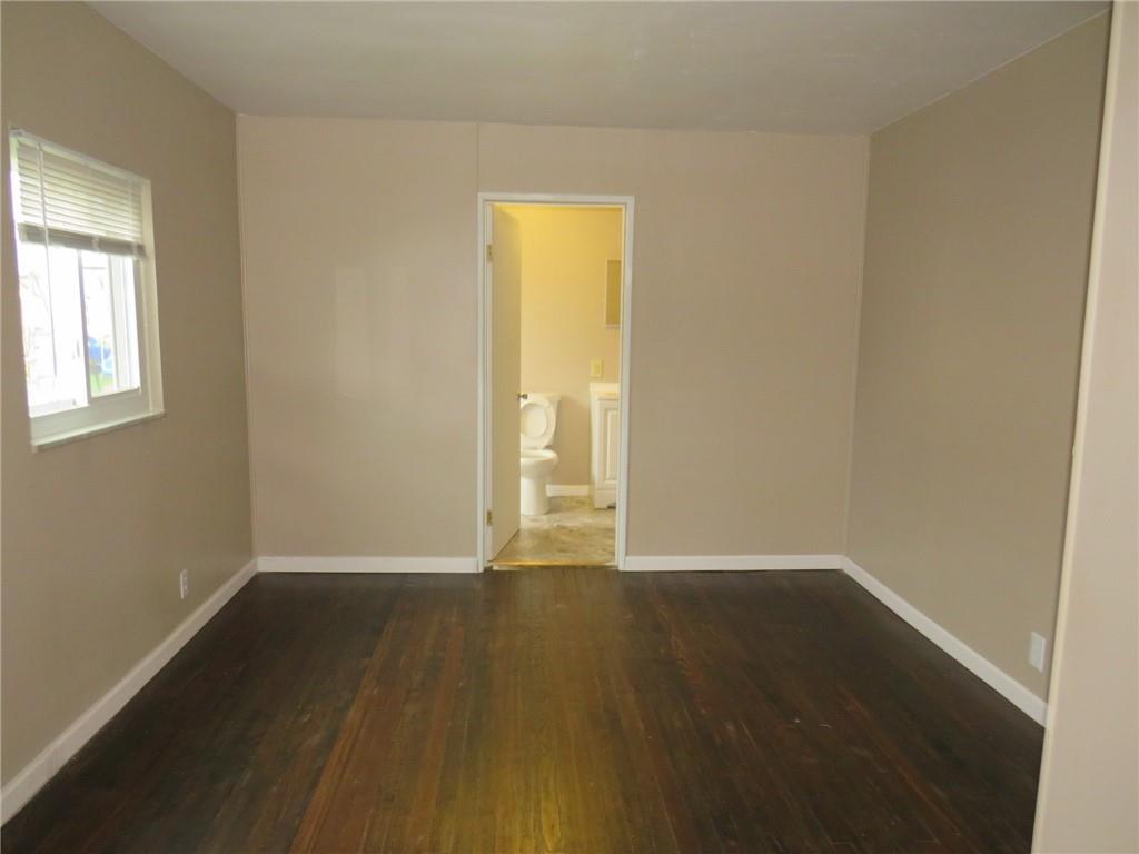 718 Ridge Avenue McKees Rocks, PA 15136 - Photo 8 of 30 a view of an empty room with wooden floor and a window