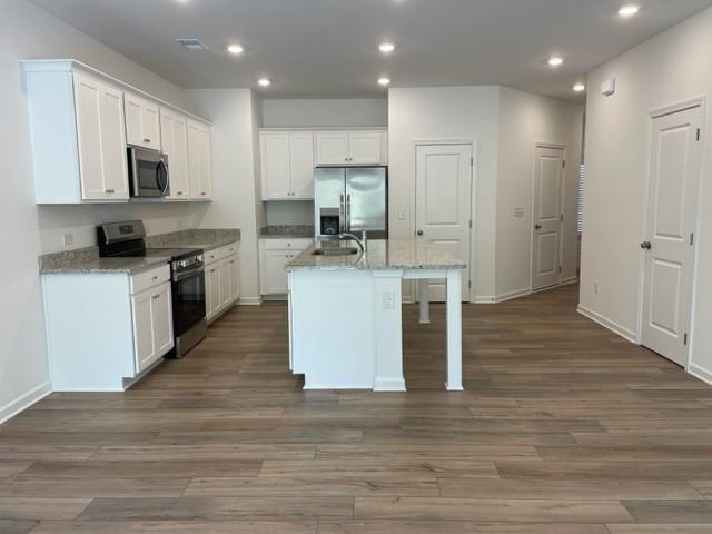 148 Vision Street Bethlehem, GA 30620 - Photo 5 of 8 a kitchen with kitchen island granite countertop a stove top oven and cabinets