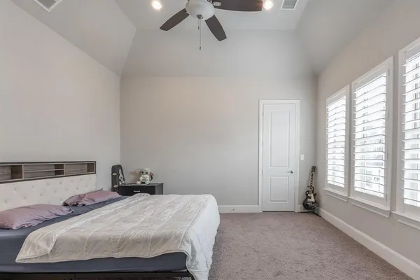 a bedroom with a bed and window