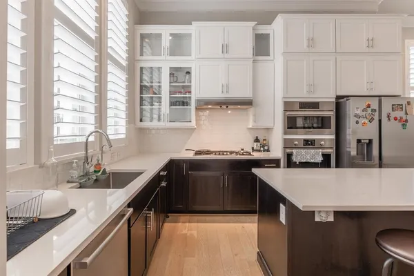 a kitchen with stainless steel appliances granite countertop a sink and cabinets
