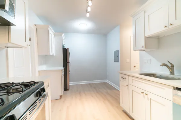 a kitchen with a sink stove and refrigerator