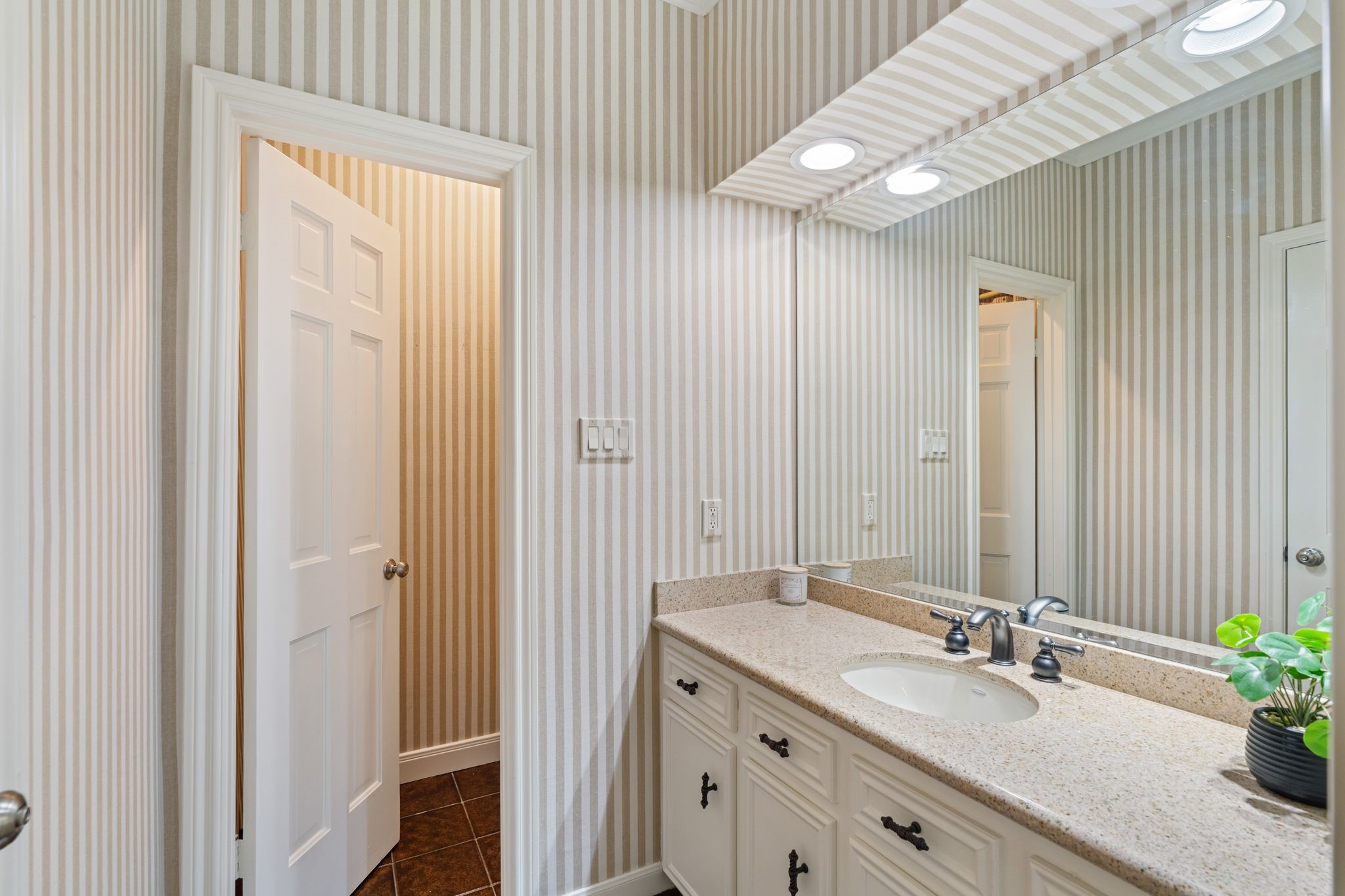 7416 Kelving Street Houston, TX 77030 - Photo 25 of 35 a bathroom with a granite countertop sink and a mirror