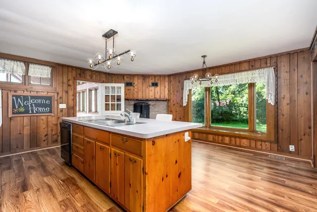 a kitchen with stainless steel appliances granite countertop a stove and a wooden floors