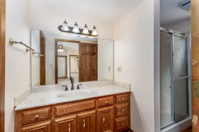 a bathroom with a sink vanity and a mirror