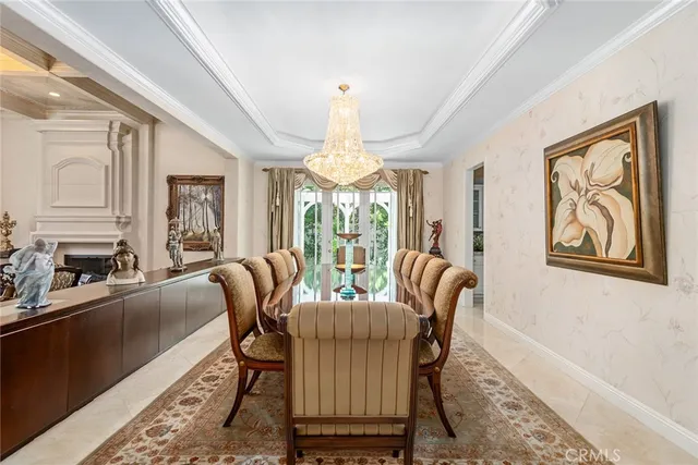 a dining room with furniture a chandelier and wooden floor