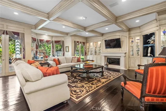 a living room with furniture fireplace and a large window