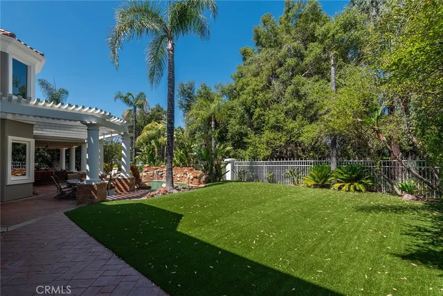 a view of a house with a backyard porch and sitting area