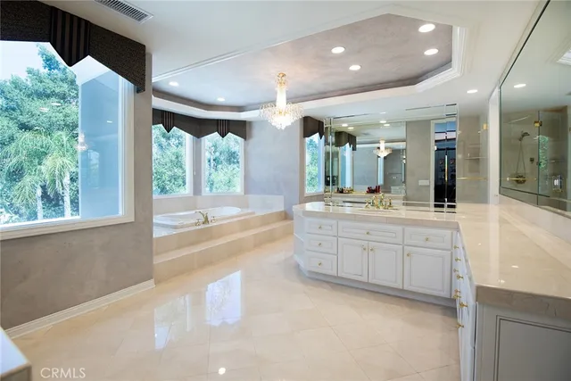 a large bathroom with a large tub and sink