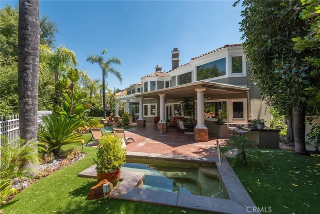 a view of a house with backyard porch and sitting area