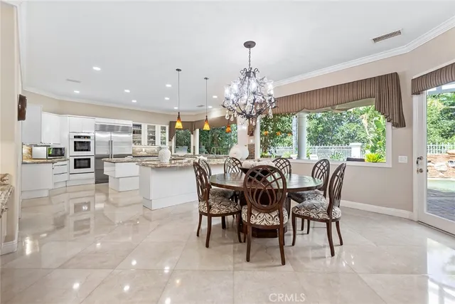 a dining room with furniture a chandelier and wooden floor