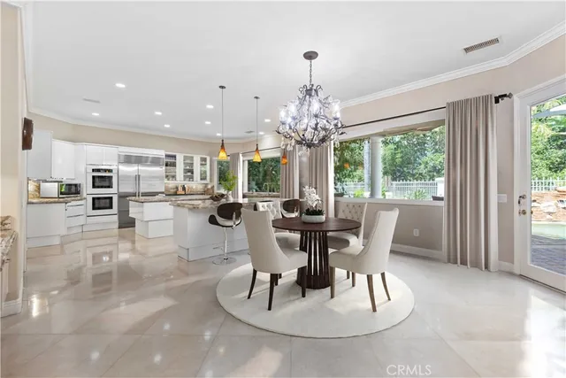 a dining room with furniture a large window and wooden floor