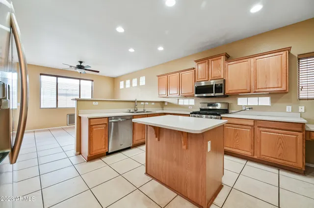 a kitchen with stainless steel appliances granite countertop a stove top oven a sink a counter top space and cabinets