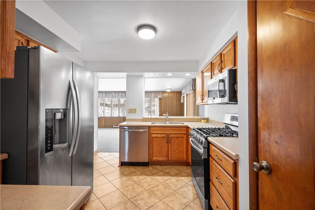 3930 Edge Road Pittsburgh, PA 15227 - Photo 13 of 45 a kitchen with stainless steel appliances granite countertop a stove a refrigerator and a sink