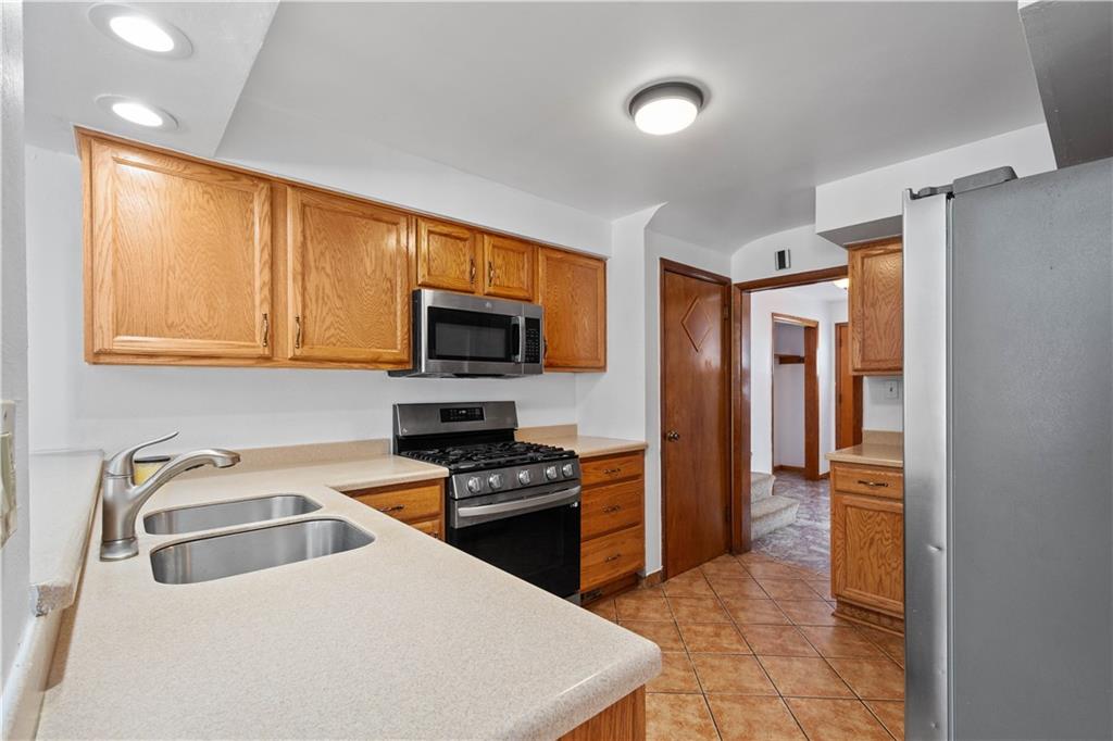 3930 Edge Road Pittsburgh, PA 15227 - Photo 14 of 45 a kitchen with stainless steel appliances a stove a sink and a refrigerator