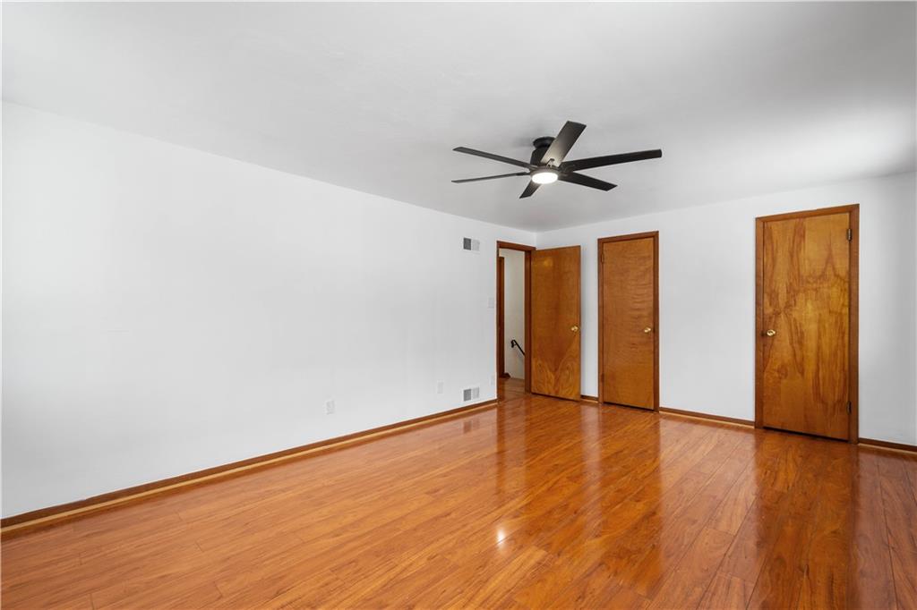 3930 Edge Road Pittsburgh, PA 15227 - Photo 19 of 45 an empty room with wooden floor and ceiling fan