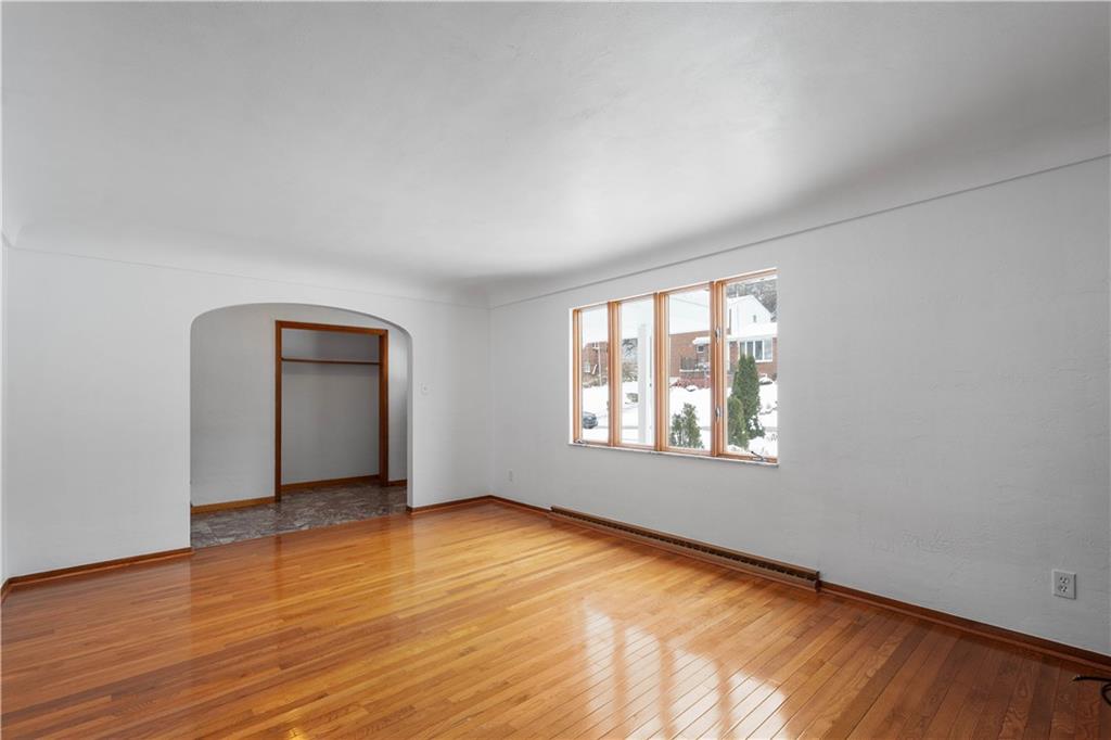 3930 Edge Road Pittsburgh, PA 15227 - Photo 8 of 45 an empty room with wooden floor and windows