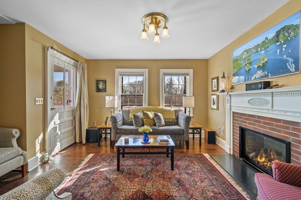 9 River Road Topsfield, MA 01983 - Photo 11 of 42 a living room with furniture and a fireplace