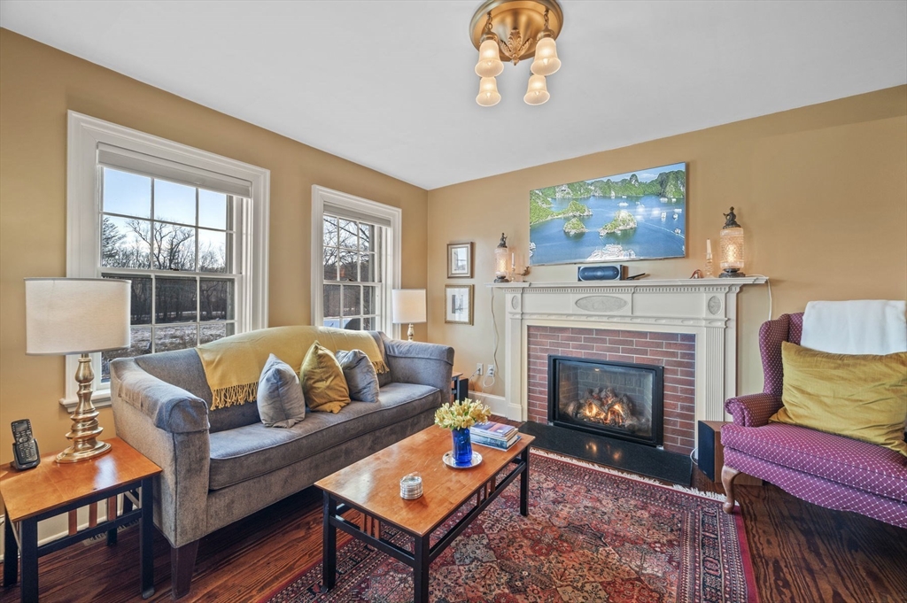 9 River Road Topsfield, MA 01983 - Photo 12 of 42 a living room with furniture a flat screen tv and a fireplace