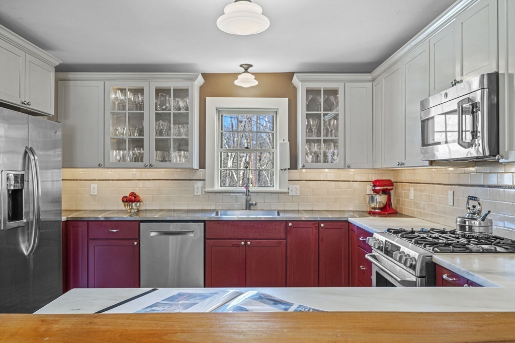 9 River Road Topsfield, MA 01983 - Photo 15 of 42 a kitchen with stainless steel appliances granite countertop a stove a sink dishwasher and a microwave