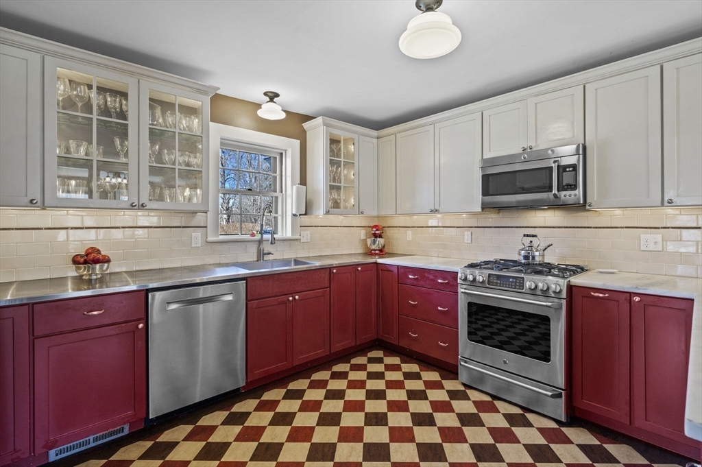 9 River Road Topsfield, MA 01983 - Photo 16 of 42 a kitchen with stainless steel appliances granite countertop a stove sink and cabinets