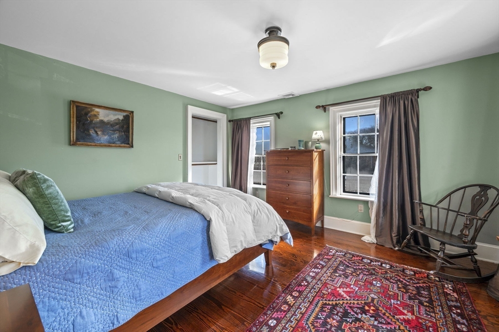 9 River Road Topsfield, MA 01983 - Photo 21 of 42 a bedroom with a bed painting on wall and a window