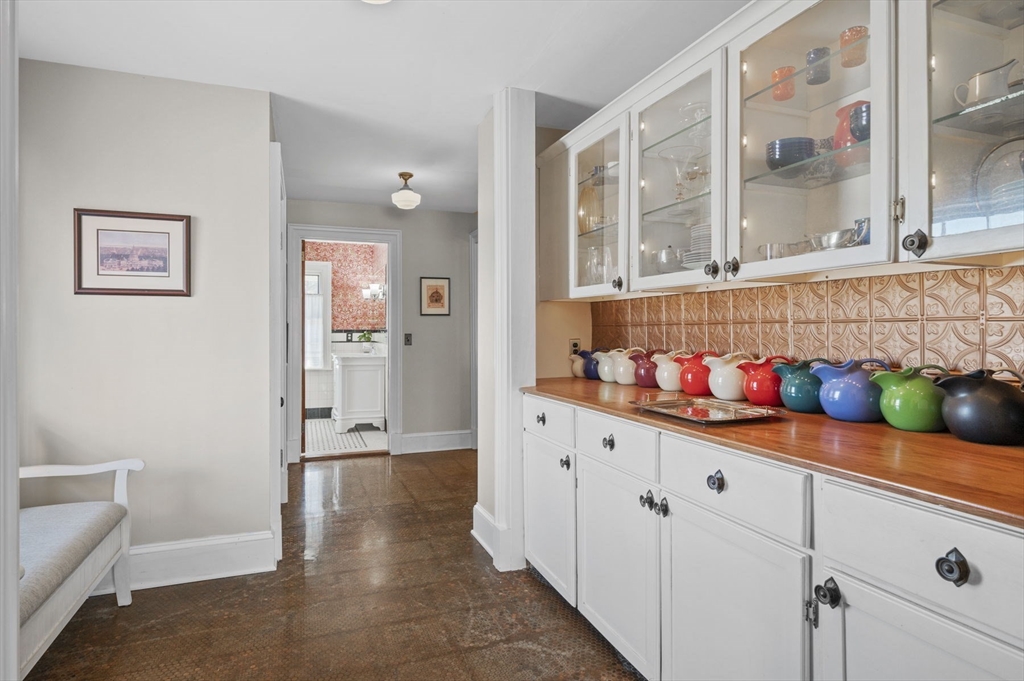 9 River Road Topsfield, MA 01983 - Photo 4 of 42 a hallway with white cabinets and wooden floor