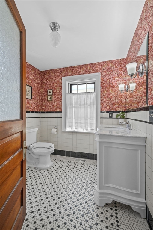 9 River Road Topsfield, MA 01983 - Photo 7 of 42 a bathroom with a toilet a sink and a window