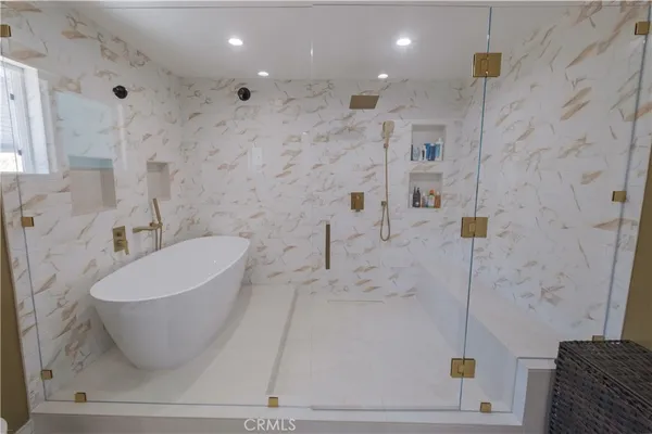 a spacious bedroom with a bed and glass windows