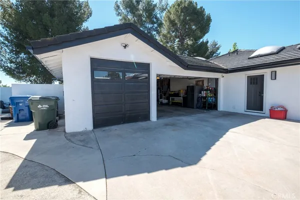 a view of a patio with a table and chairs