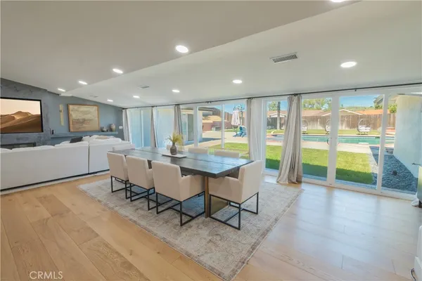 a kitchen with stainless steel appliances a stove a sink a microwave a refrigerator and cabinets