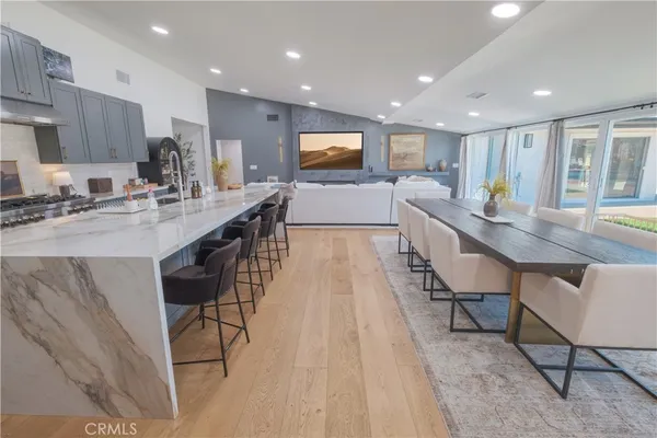a kitchen with stainless steel appliances granite countertop a sink counter space and a stove