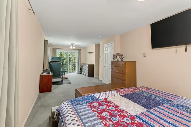 a bedroom with a bed and flat screen tv
