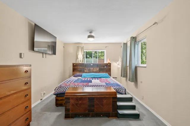 a bedroom with a bed and a window