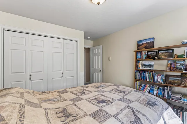 a bedroom with a bed and a book shelf