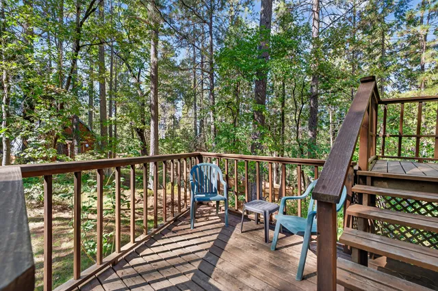 a view of balcony with wooden floor and fence