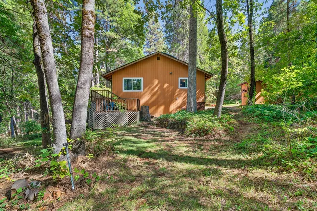 a view of a house with yard and sitting area