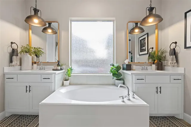 a spacious bathroom with a sink a large mirror and a bathtub