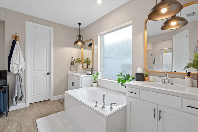a bathroom with a sink and a mirror or bathtub