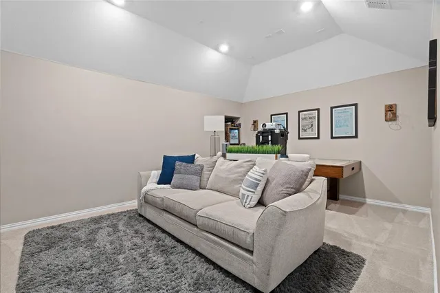 a living room with furniture and painting on the wall