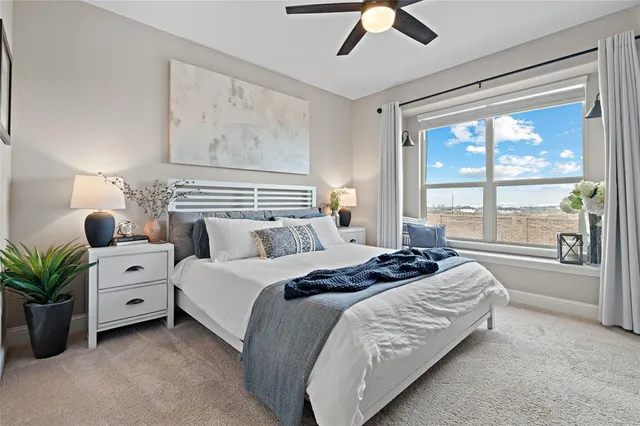 a bedroom with bed and a large window