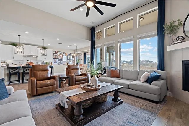 a living room with furniture ceiling fan and a rug