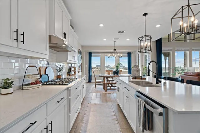 a kitchen with sink stove and cabinets
