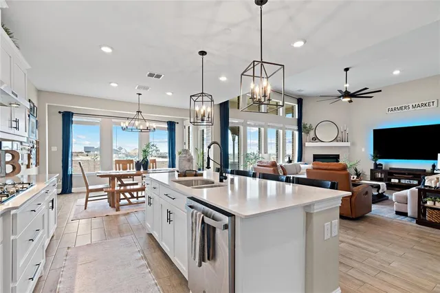 a large kitchen with stainless steel appliances kitchen island granite countertop a large center island attached withe living room