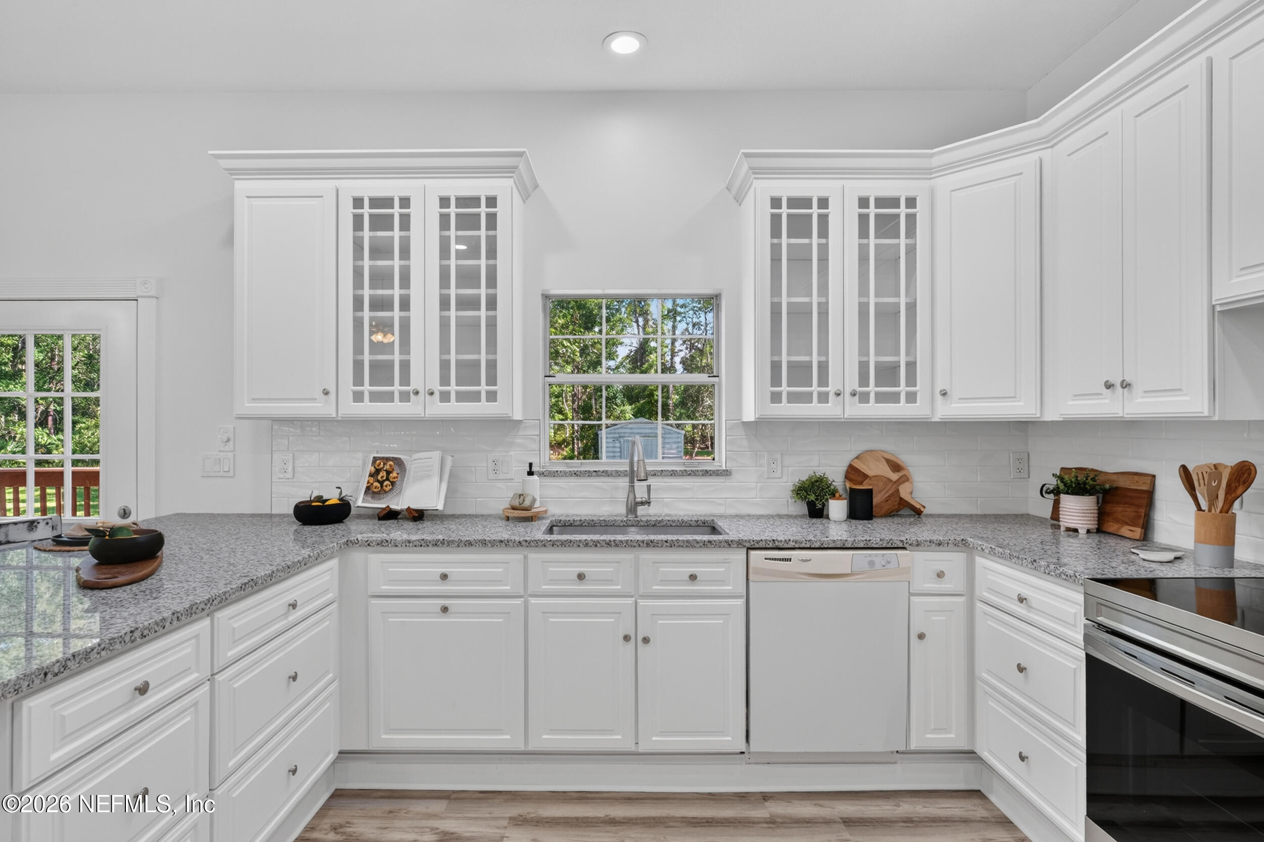 3090 Monument Bay Road St. Augustine, FL 32092 - Photo 13 of 56 a kitchen with white cabinets and white appliances