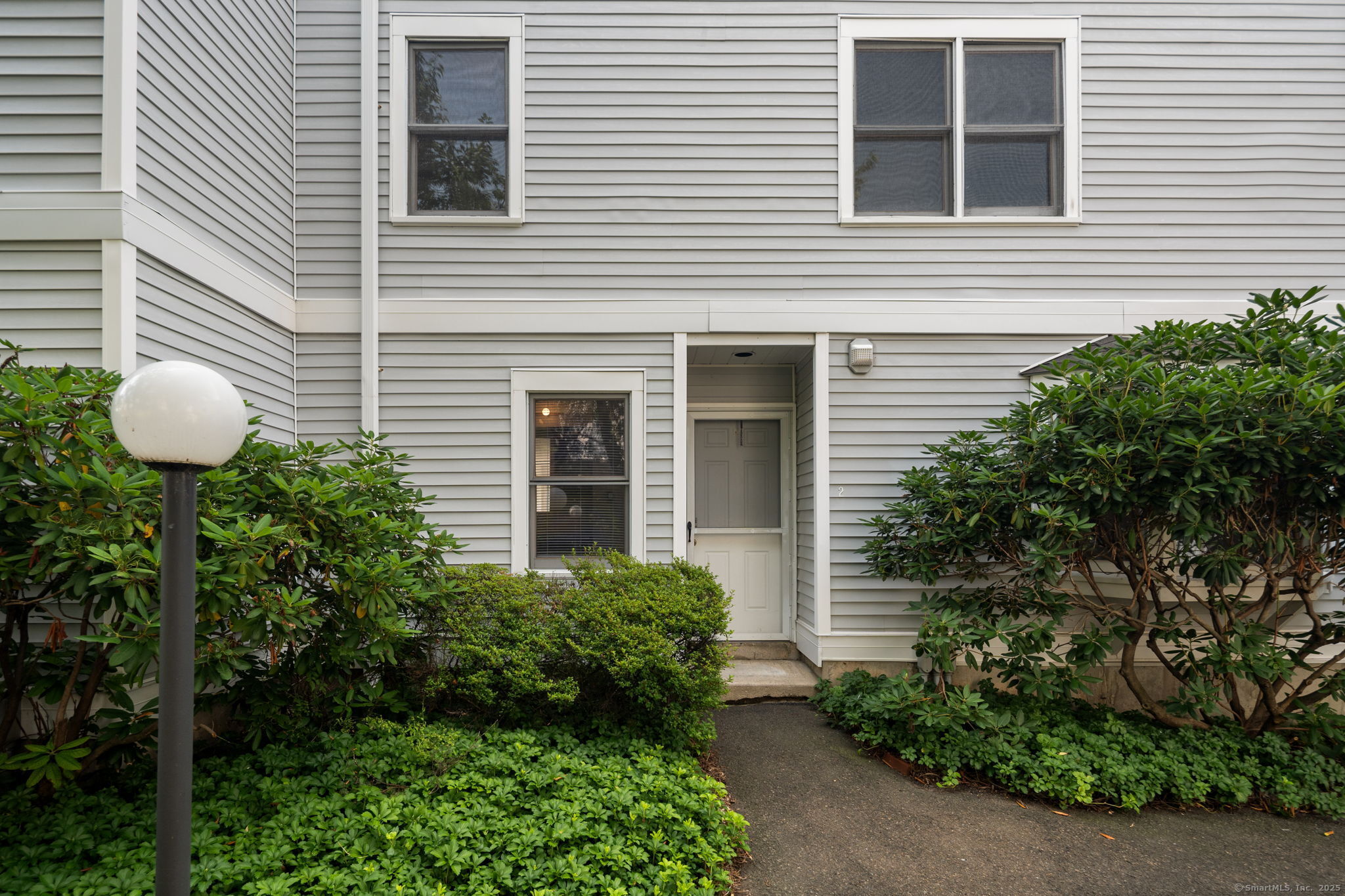 a view of a chair and table in backyard of the house