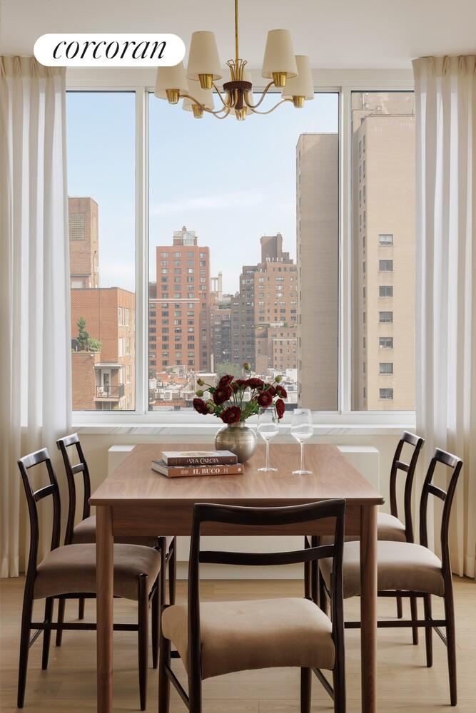400 East 84th Street, Unit 22C Manhattan, NY 10028 - Photo 4 of 10 a view of a dining room with furniture window and outside view