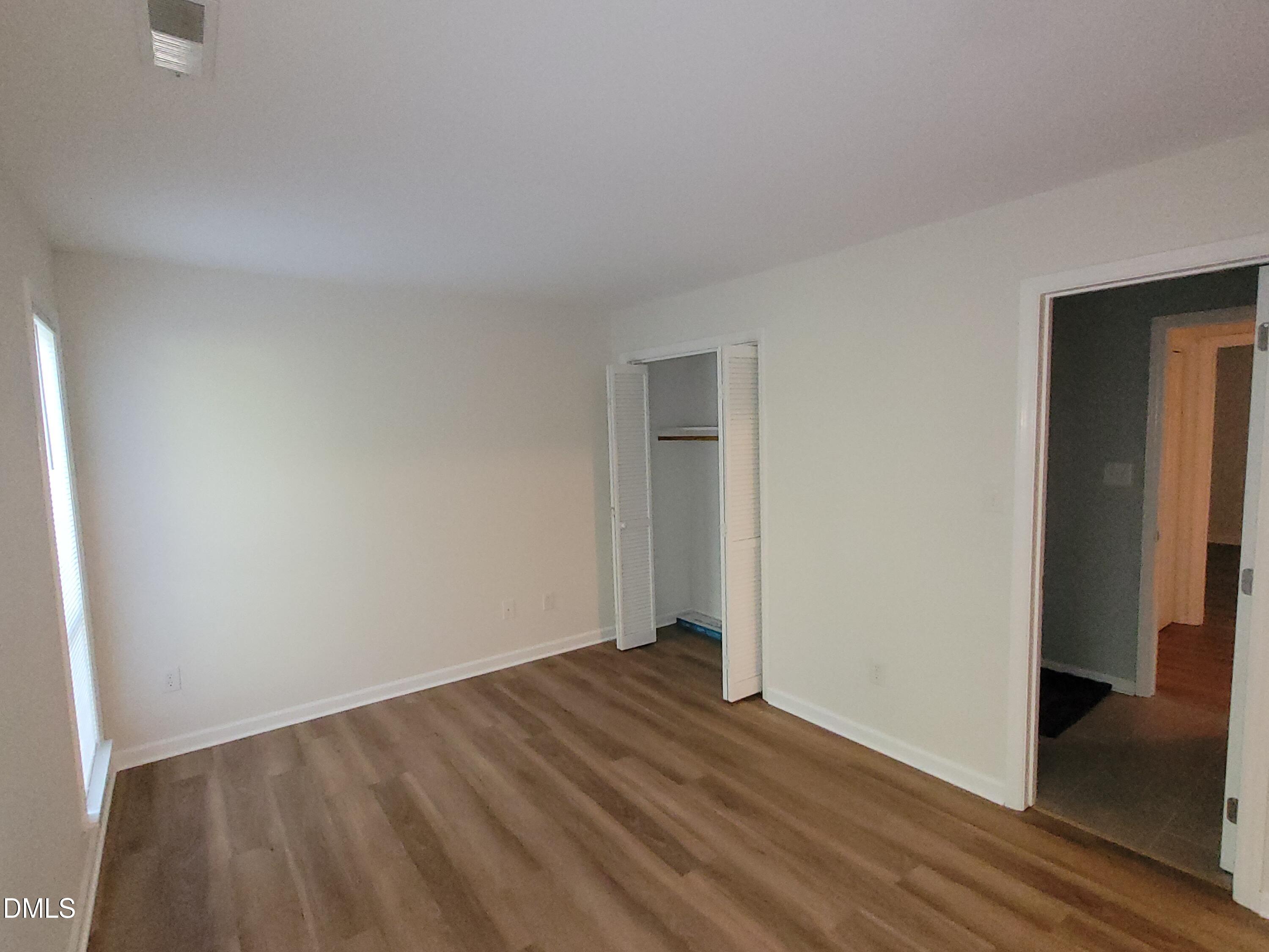 4651 Timbermill Court, Unit 103 Raleigh, NC 27612 - Photo 28 of 40 Wood-finish flooring, white walls, and a bi-fold door closet